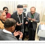 Group offering prayers in hospital.