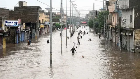 Flood-affected area in Pakistan 2025 showing submerged villages and displaced families amid NDMA relief operations