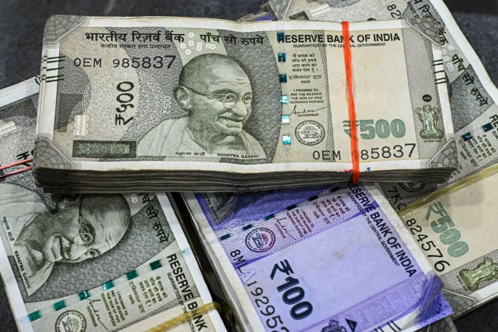 Indian rupee and US dollar currency notes side by side showing rupee depreciation trend 2026