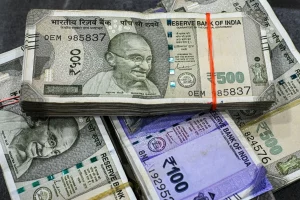 Indian rupee and US dollar currency notes side by side showing rupee depreciation trend 2026