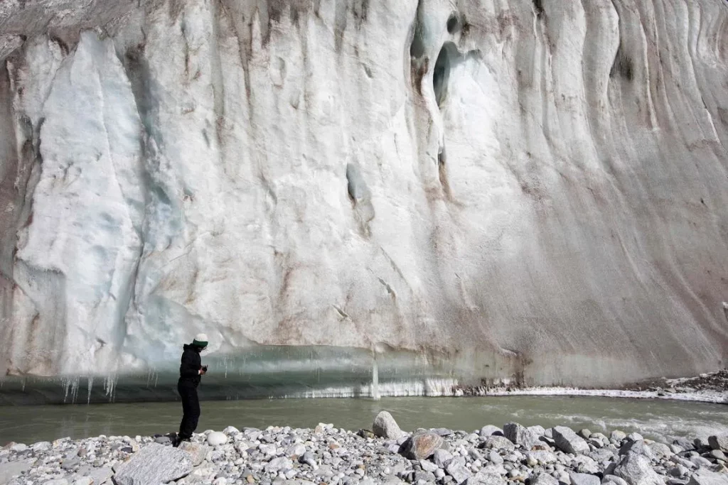 Melting glaciers in Pakistan's Karakoram mountain range with glacial lake forming in the valley below