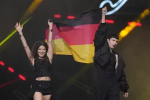 Eurovision Song Contest 2026 logo and Vienna stage with competing nations' flags displayed at Wiener Stadthalle