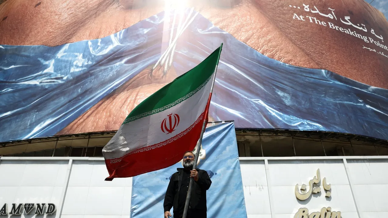 A billboard in Tehran showing the Strait of Hormuz with a graphic of US President Donald Trump, reflecting tensions during the Iran Trump war in May 2026.