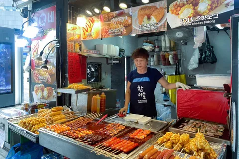 A table spread of Korean BBQ, kimchi, and banchan side dishes at a popular Korean restaurant in Karachi, Pakistan