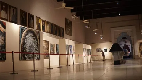 Visitors exploring paintings at an upcoming art exhibition in Lahore gallery, 2026