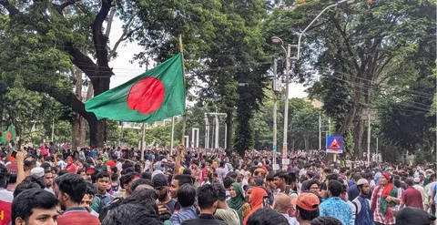 Bangladeshi voters stand in long queues at a polling station during the February 12 2026 parliamentary election in Dhaka Bangladesh