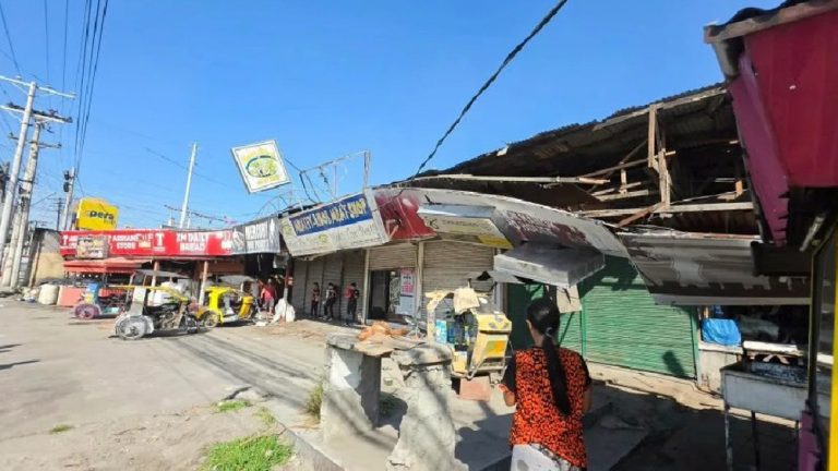 Rescue teams and residents gather after the Philippines earthquake today tsunami warning near coastal affected areas.