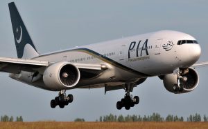 Government officials reviewing documents related to PIA privatization plan and aviation sector restructuring in Pakistan.