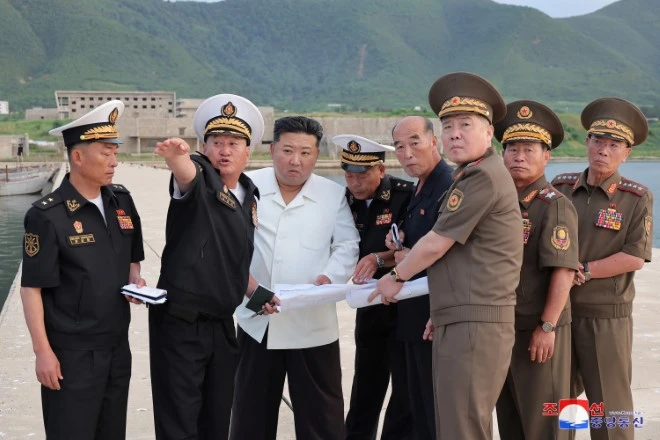 North Korean naval fleet and warship construction scene showing military expansion after Kim Jong Un’s order for a 10,000-ton destroyer development.