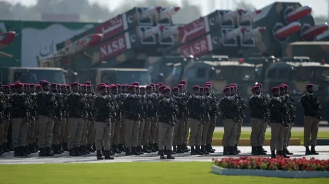 Pakistan military rank in 2026 showing Pakistan Army soldiers during a military parade with modern defense equipment and national flag in the background.