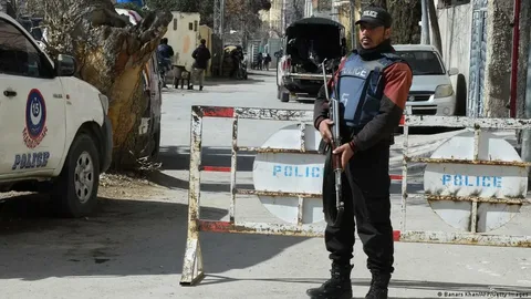 Security personnel securing a road in Khyber Pakhtunkhwa after a deadly attack as authorities investigate the latest Pakistan blast news.