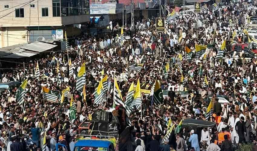 People gathered during a peaceful protest in Azad Kashmir while security officials monitor the situation.