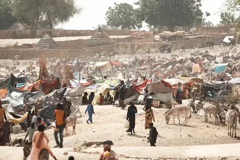 Displaced Sudanese families queue for food and water at a crowded camp in North Kordofan, Sudan