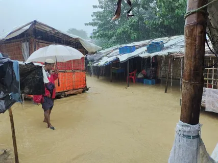 Rescue workers search debris after coastal flooding in Bangladesh triggers a landslide at a Rohingya refugee camp in Cox's Bazar