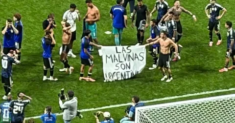 Argentina players hold "Las Malvinas Son Argentinas" banner after beating England in the 2026 World Cup semi-final, sparking FIFA controversy.