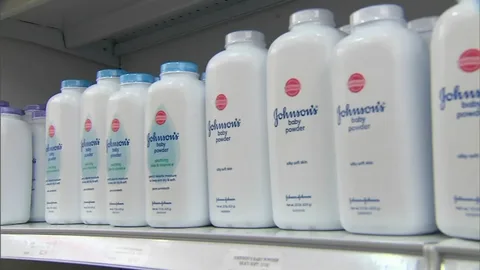 Johnson's Baby Powder bottles on a shelf representing the Johnson and Johnson baby powder scandal and ongoing talc lawsuit settlement in 2026