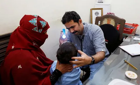 Children and parents gathered outside a government hospital in Sindh, Pakistan, amid rising HIV cases in 2025