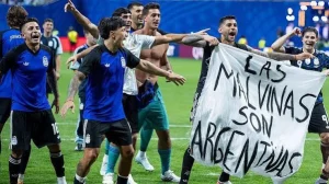 Argentina players hold a banner referencing the Falkland Islands after the World Cup semifinal against England.