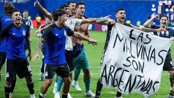 Argentina players hold a banner referencing the Falkland Islands after the World Cup semifinal against England.