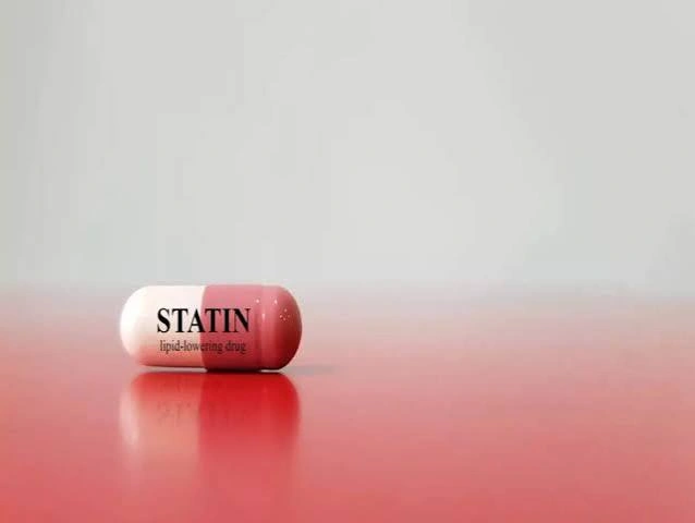 Doctor reviewing cholesterol test results under the new cholesterol guidelines that expand statin eligibility.