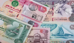 UAE Dirham banknotes alongside Pakistani Rupee currency representing the AED to PKR exchange rate