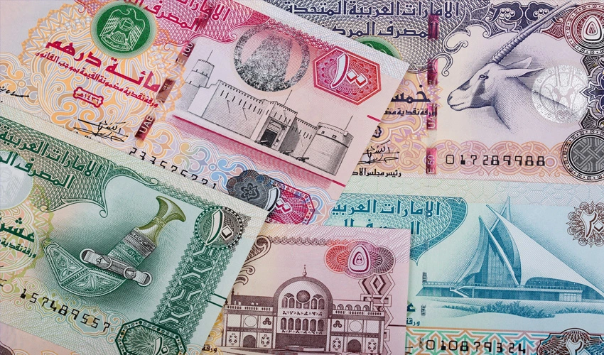 UAE Dirham banknotes alongside Pakistani Rupee currency representing the AED to PKR exchange rate