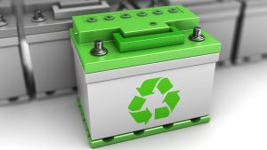 Workers sorting used lithium-ion batteries at a battery recycling facility