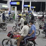 Small vehicle subsidy in Pakistan – motorcycle and small car at a fuel pump amid high fuel prices