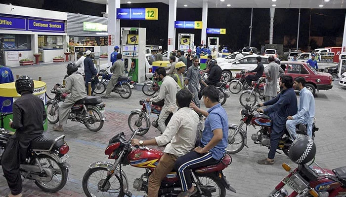 Small vehicle subsidy in Pakistan – motorcycle and small car at a fuel pump amid high fuel prices
