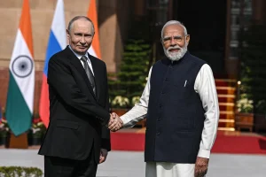 India economic measures against Russia sanctions — cargo ship carrying oil barrels with Indian and Russian trade route map