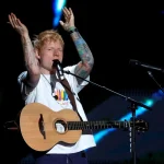 Macklemore performing live on stage before being dropped from Ed Sheeran's Loop Tour