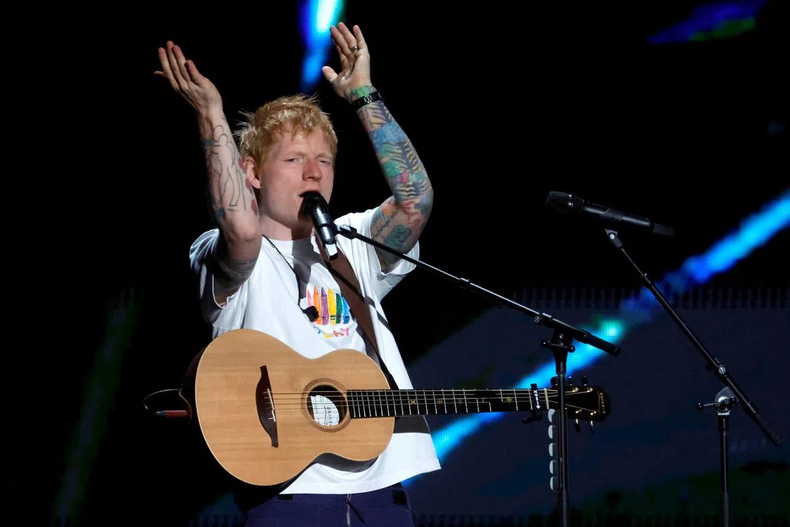 Macklemore performing live on stage before being dropped from Ed Sheeran's Loop Tour