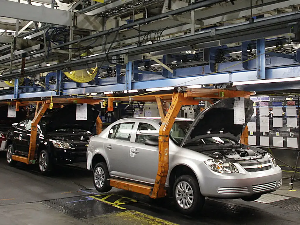 Rows of newly assembled cars at a Pakistani auto plant under the new auto policy Pakistan 2026-31