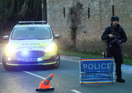 Armed UK police guard a roadblock near RAF Fairford after five men were arrested on suspicion of explosives and terrorism offences