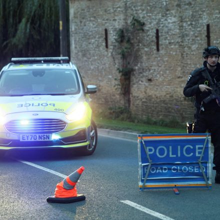 Armed UK police guard a roadblock near RAF Fairford after five men were arrested on suspicion of explosives and terrorism offences