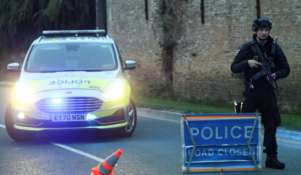 Armed UK police guard a roadblock near RAF Fairford after five men were arrested on suspicion of explosives and terrorism offences