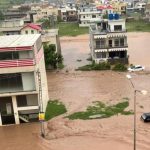 Rescue workers and dewatering pumps deployed on a flooded road in Islamabad during the September 2026 monsoon flooding