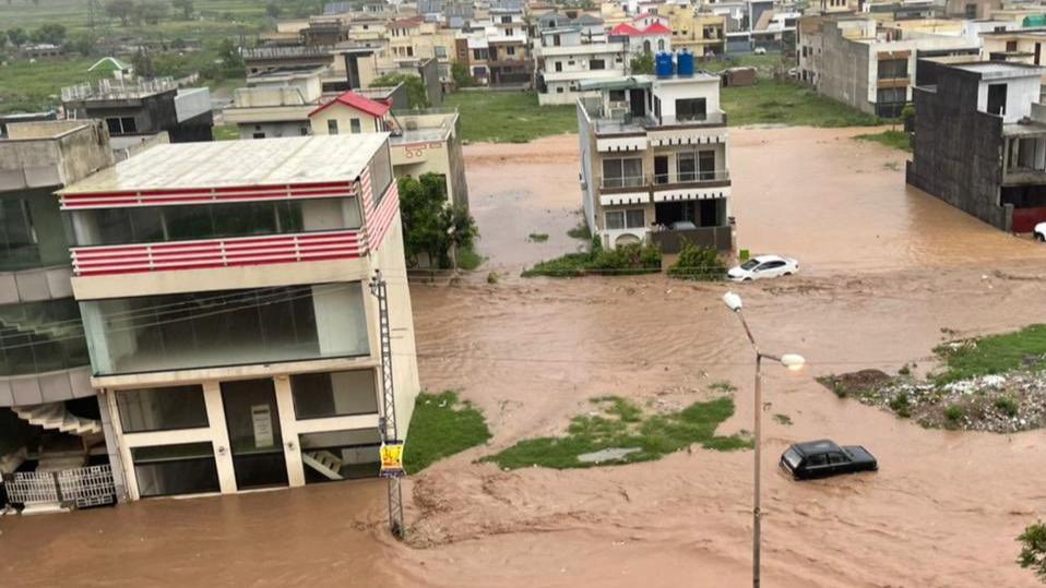 Rescue workers and dewatering pumps deployed on a flooded road in Islamabad during the September 2026 monsoon flooding