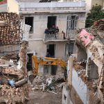 Emergency responders inspect the site of the Athens explosion in the Plaka district near the Acropolis