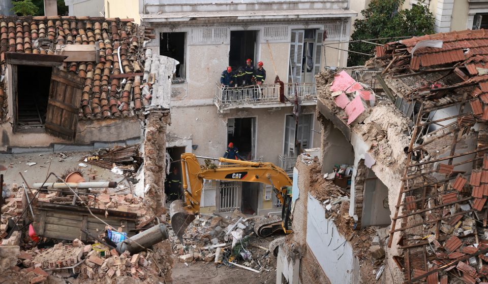 Emergency responders inspect the site of the Athens explosion in the Plaka district near the Acropolis