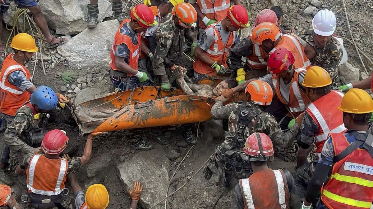 Nepal engineering rescue team members reviewing tunnel drawings during hydropower plant rescue operations