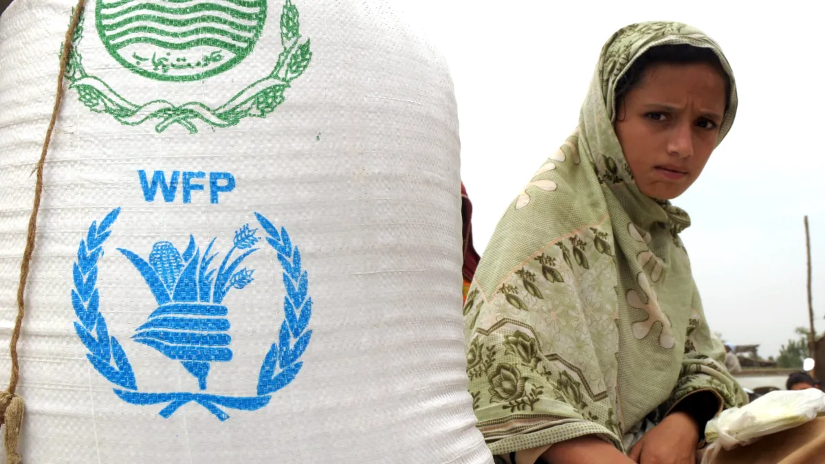 A mother and young child receive nutrition screening support under a WFP Pakistan program at a facilitation centre