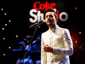 Coke Studio logo displayed alongside a music studio setup with instruments
