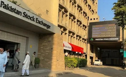 Investors watch the share price board at the Pakistan Stock Exchange in Karachi as the KSE-100 turns negative