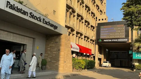 Investors watch the share price board at the Pakistan Stock Exchange in Karachi as the KSE-100 turns negative