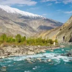 Snow-capped mountains in Gilgit-Baltistan with a mobile tower in the foreground, symbolising poor internet connectivity in GB