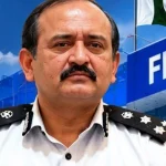 FIA pre-departure immigration facilitation desk assisting international travellers at Faisalabad Airport. Copy ALT Text