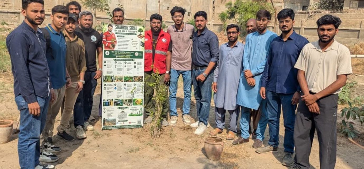 Volunteers plant fruit tree saplings at a fruit orchard initiative in Malir, Karachi.