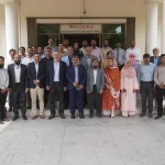 Agricultural scientists examine wheat crops as CIMMYT and AARI strengthen wheat research in Pakistan.