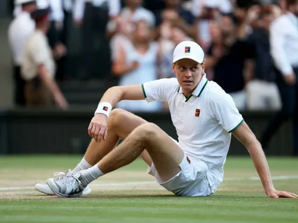 Jannik Sinner holding the Wimbledon trophy before his knee injury ended his 2026 tennis season